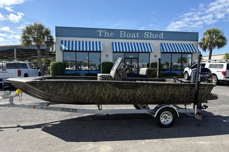 The Image of 2026 SeaArk Shadow 19 V Center Console boat on trailer outside The Boat Shed. - 1