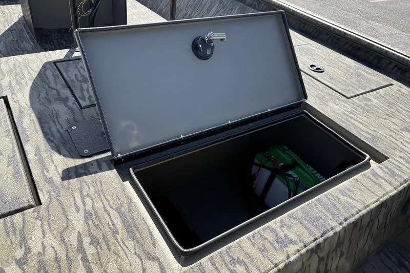 Slide: The Image of Open storage compartment on 2026 SeaArk Shadow 19 V Center Console boat. - 10