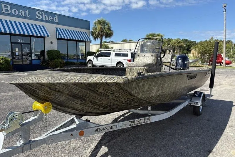 Slide: The Image of 2026 SeaArk Shadow 19 V Center Console boat on trailer outside dealership. - 11
