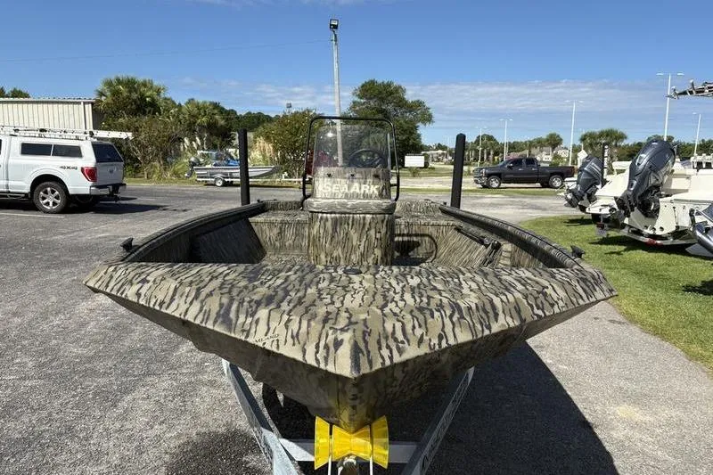 Slide: The Image of 2026 SeaArk Shadow 19 V Center Console boat with camouflage design on a trailer. - 12