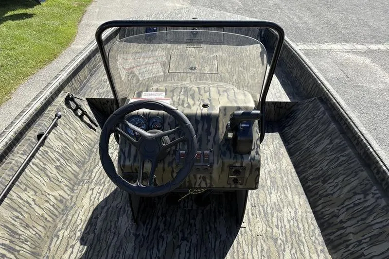 Slide: The Image of 2026 SeaArk Shadow 19 V Center Console with camouflage design, featuring steering wheel and controls. - 6