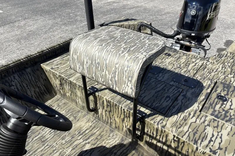 Slide: The Image of 2026 SeaArk Shadow 19 V Center Console boat with camouflage seating and steering wheel. - 7