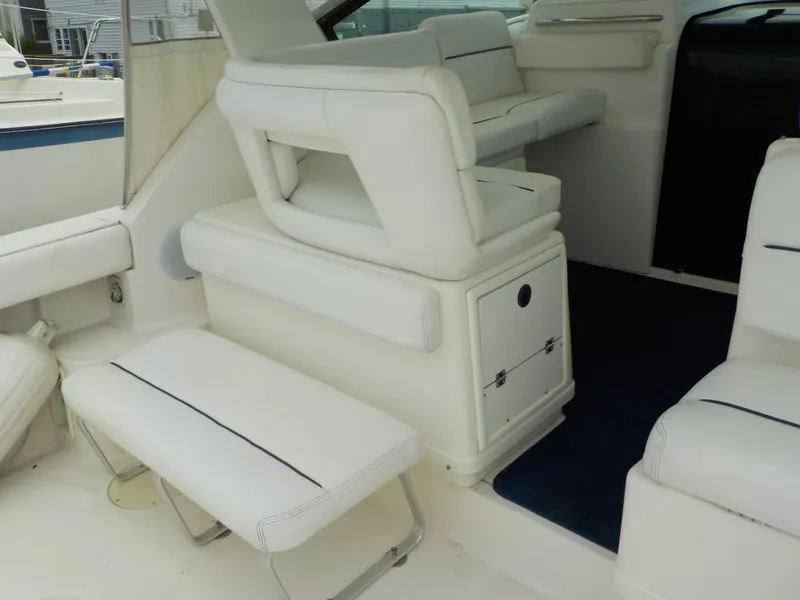 Slide: The Image of 2003 Tiara Yachts 3100 Open interior with white seating and storage compartments. - 10