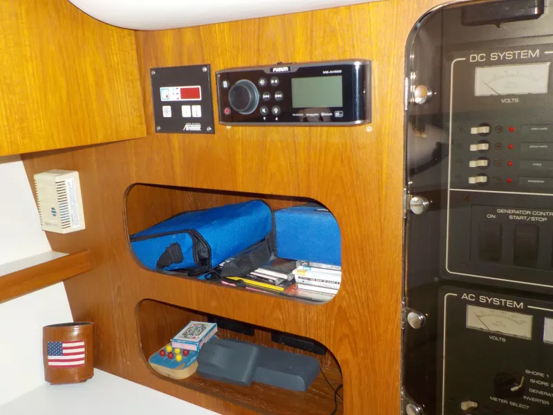 Slide: The Image of 2003 Tiara Yachts 3100 Open cabin with control panel and storage shelves. - 13