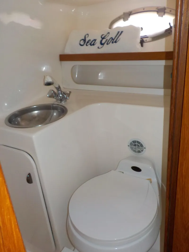 Slide: The Image of Compact bathroom in 2003 Tiara Yachts 3100 Open, featuring sink and toilet. - 16