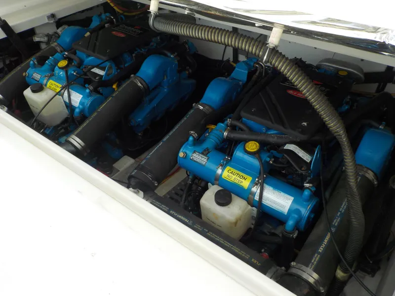 Slide: The Image of Engine compartment of a 2003 Tiara Yachts 3100 Open, featuring dual blue marine engines. - 19