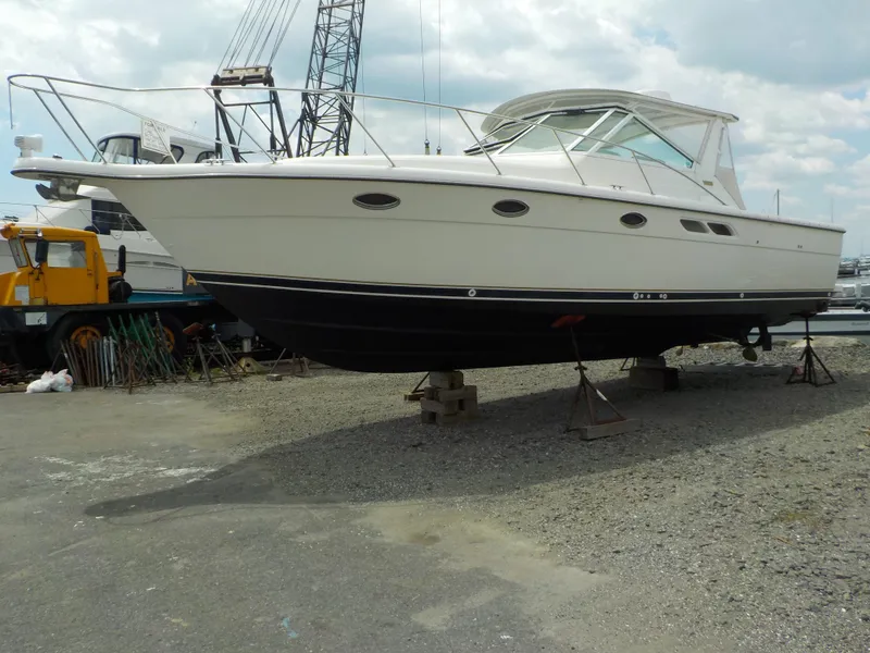 Slide: The Image of 2003 Tiara Yachts 3100 Open on dry dock, side view, overcast sky. - 2