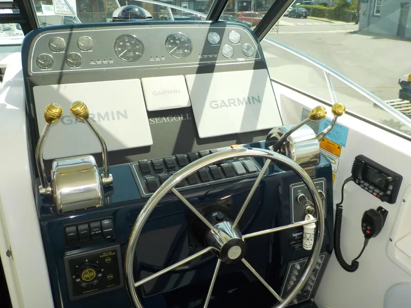 Slide: The Image of 2003 Tiara Yachts 3100 Open helm with Garmin navigation and control panel. - 4