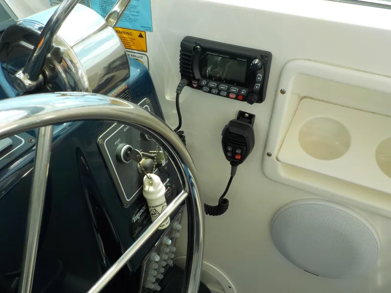 Slide: The Image of Helm of 2003 Tiara Yachts 3100 Open with steering wheel and communication equipment. - 6