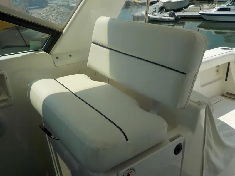 Slide: The Image of White cushioned seat on 2003 Tiara Yachts 3100 Open, docked at marina. - 7