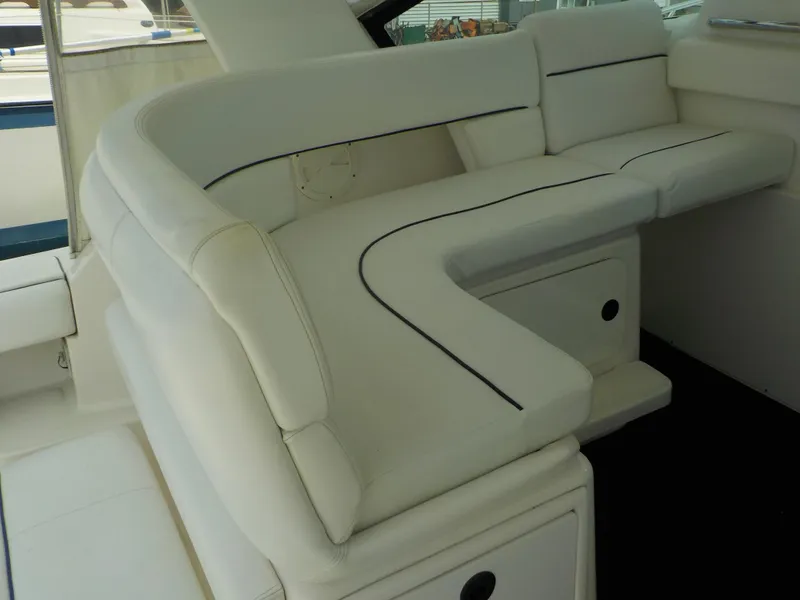 Slide: The Image of 2003 Tiara Yachts 3100 Open interior with white cushioned seating. - 8