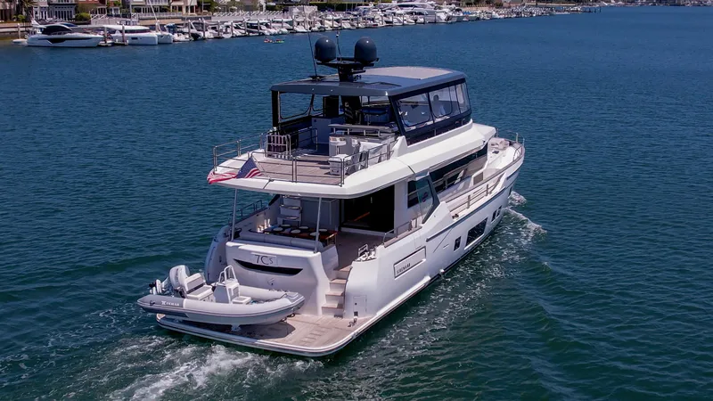 Slide: The Image of 2023 Sirena 68 yacht cruising in a marina. - 1