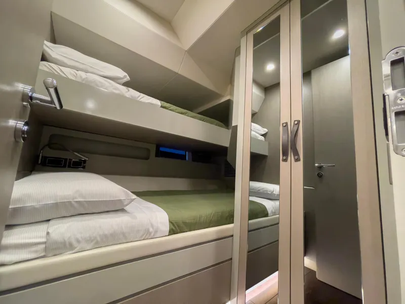 Slide: The Image of 2023 Sirena 68 yacht interior with bunk beds and mirrored closet. - 22