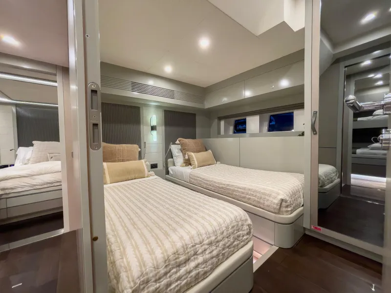 Slide: The Image of Modern twin bedroom on the 2023 Sirena 68 yacht with sleek design and ambient lighting. - 23