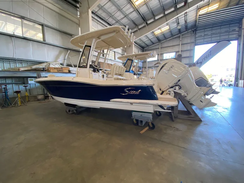 The Image of 2026 Scout 215 XSF boat in a warehouse, featuring a sleek design and powerful engines. - 0