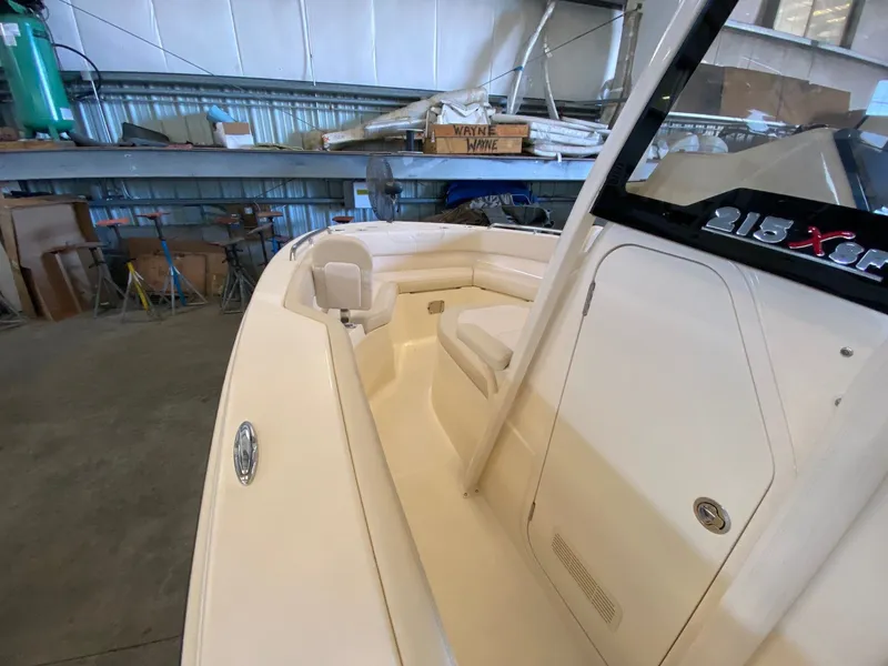 Slide: The Image of 2026 Scout 215 XSF boat interior in a workshop setting, showcasing seating and storage. - 10