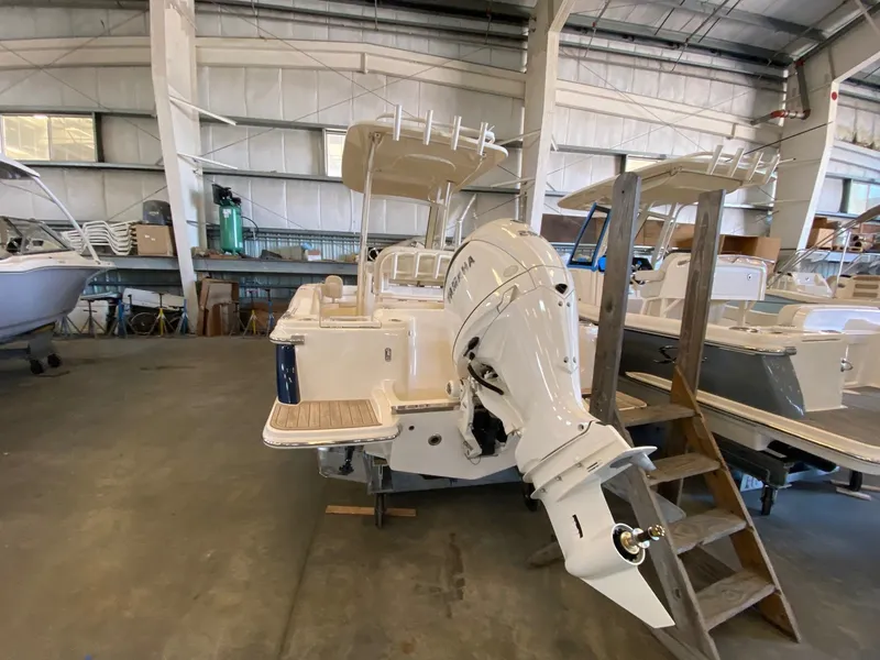 Slide: The Image of 2026 Scout 215 XSF boat with Yamaha outboard motor in a storage facility. - 3