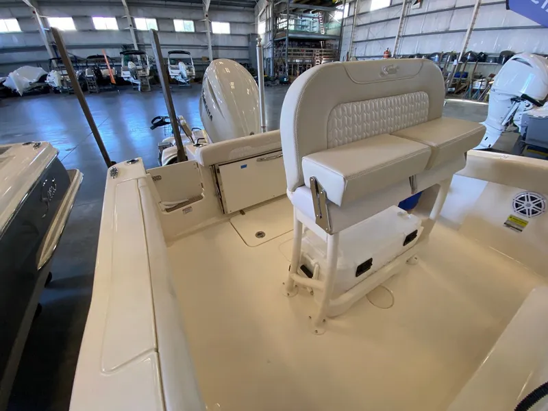 Slide: The Image of 2026 Scout 215 XSF boat interior with seating and motor in a showroom. - 8