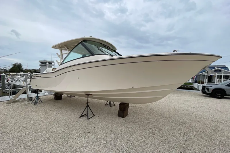 The Image of 2026 Grady-White Freedom 325 boat displayed on stands in a marina setting. - 0