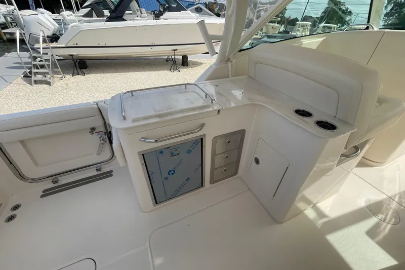 Slide: The Image of 2026 Grady-White Freedom 325 boat interior with storage and seating area. - 14