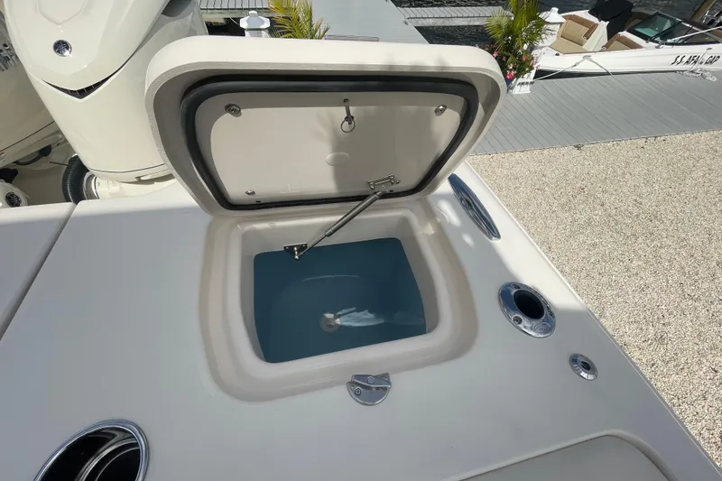 Slide: The Image of Open storage compartment on 2026 Grady-White Freedom 325 boat deck. - 18