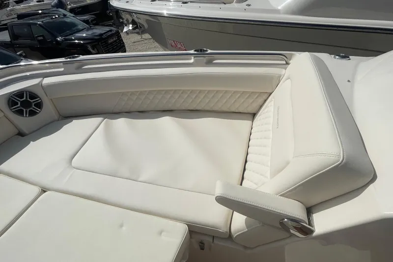 Slide: The Image of 2026 Grady-White Freedom 325 boat interior with luxurious white seating and speaker. - 2