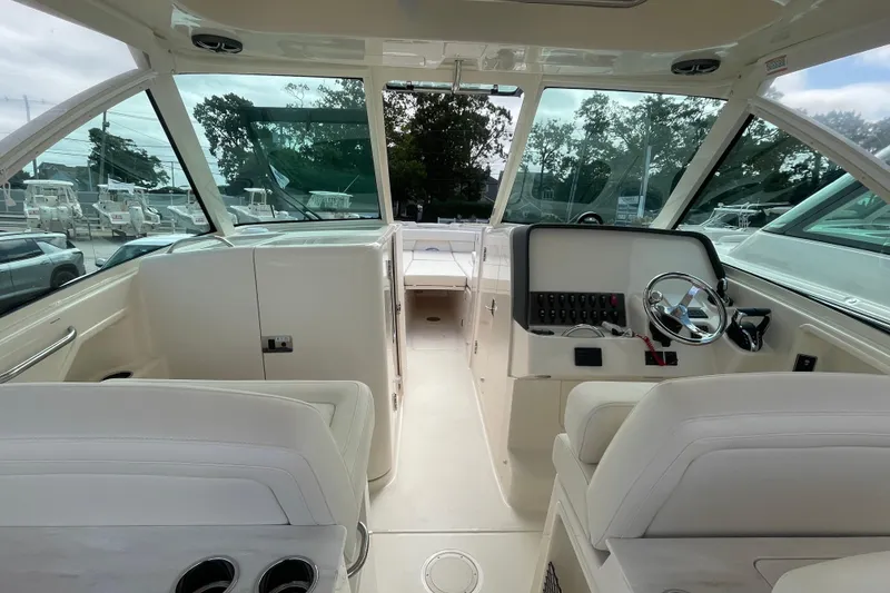 Slide: The Image of 2026 Grady-White Freedom 325 boat interior with steering wheel and seating. - 4