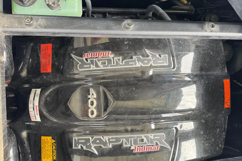 Slide: The Image of 2022 Tigé Z3 boat engine, Raptor Indmar 400, with caution labels visible. - 11