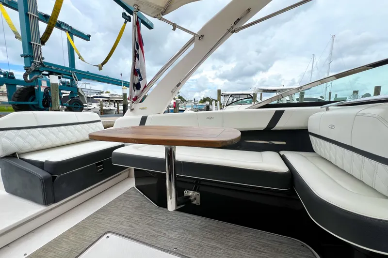Slide: The Image of 2019 Regal 29 OBX boat interior with elegant seating and wooden table. - 11