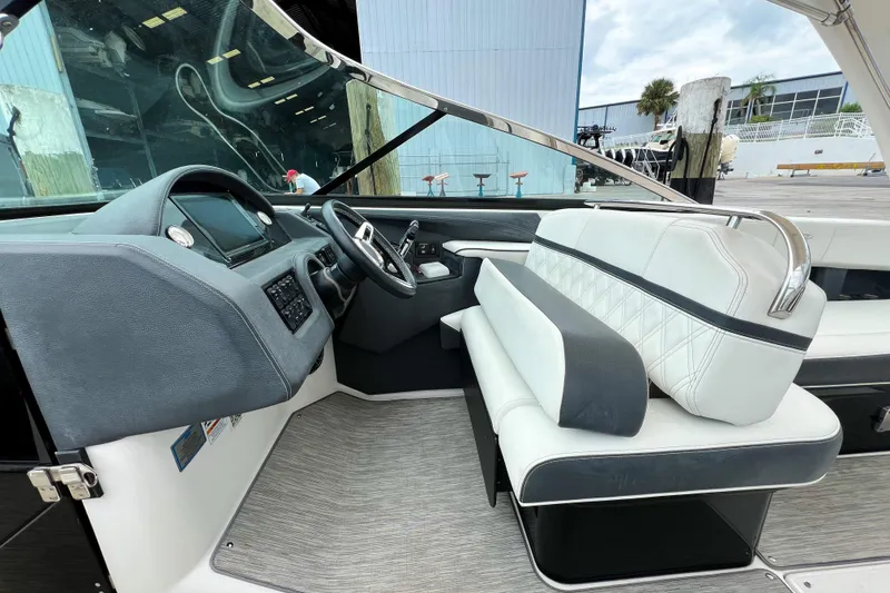 Slide: The Image of Interior of 2019 Regal 29 OBX boat with modern dashboard and seating. - 14