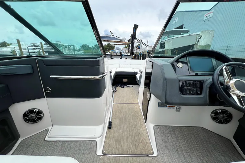Slide: The Image of 2019 Regal 29 OBX boat interior with modern dashboard and spacious seating. - 17