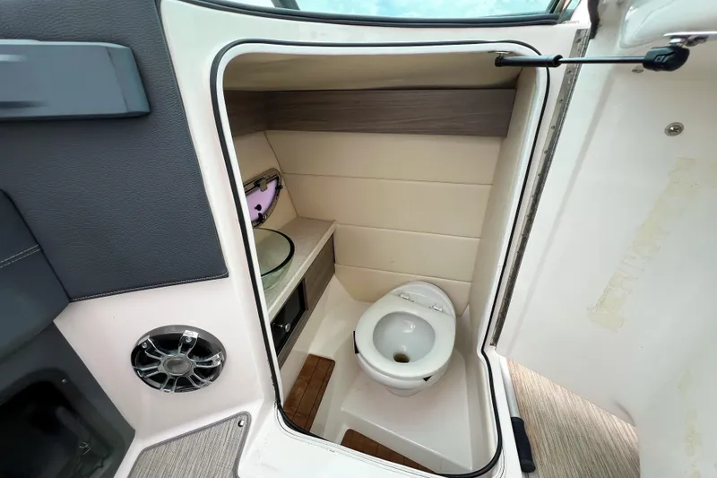 Slide: The Image of 2019 Regal 29 OBX boat interior bathroom with toilet and sink. - 18
