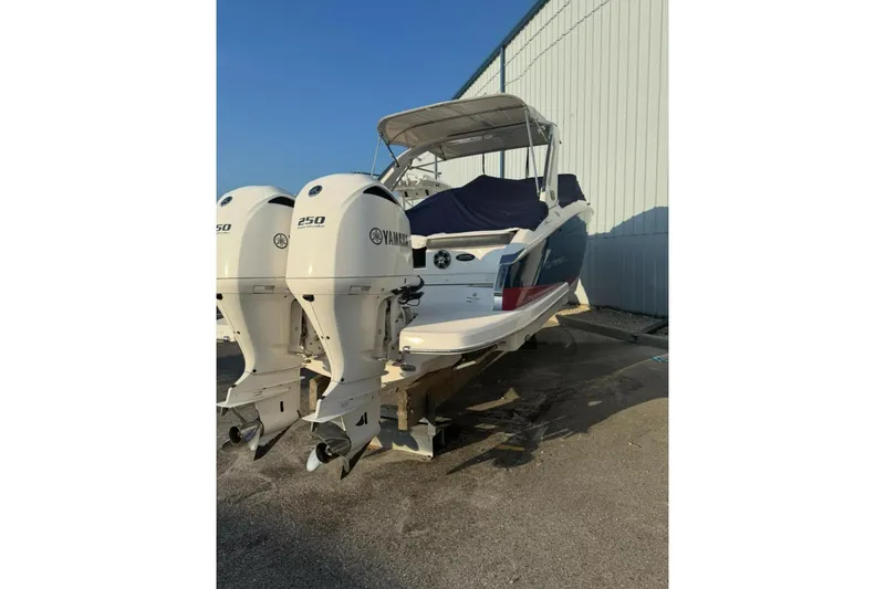 Slide: The Image of 2019 Regal 29 OBX boat with twin Yamaha 250 engines, docked outdoors. - 22