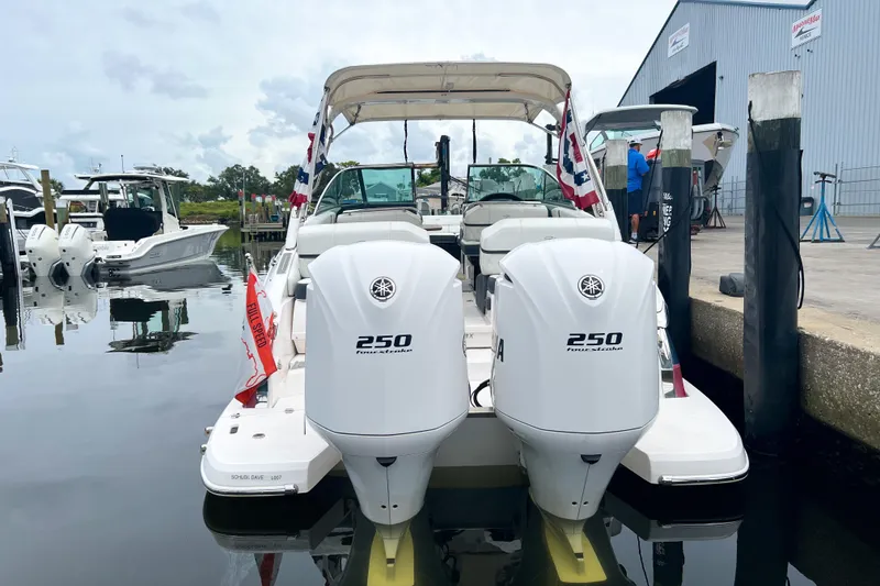 Slide: The Image of 2019 Regal 29 OBX boat with twin 250 horsepower engines docked at marina. - 3