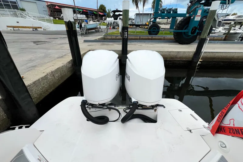 Slide: The Image of 2019 Regal 29 OBX boat with twin Yamaha outboard engines at a marina dock. - 5