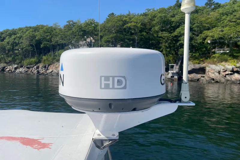 Slide: The Image of Radar equipment on a 2012 Hunt Surfhunter boat, with scenic shoreline background. - 10