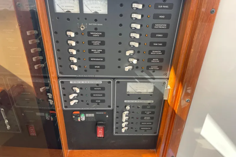 Slide: The Image of Electrical control panel on a 2012 Hunt Surfhunter boat, featuring various switches and meters. - 14