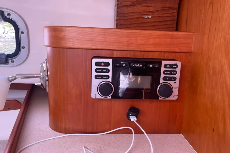 Slide: The Image of Clarion stereo system on 2012 Hunt Surfhunter boat with wooden interior. - 17