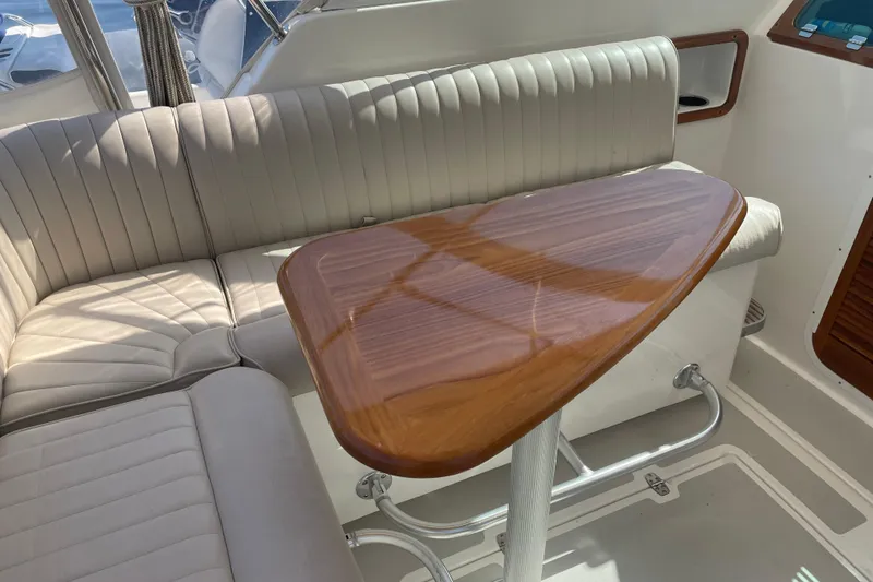 Slide: The Image of Luxurious interior of 2012 Hunt Surfhunter boat with elegant wood table and cushioned seating. - 19