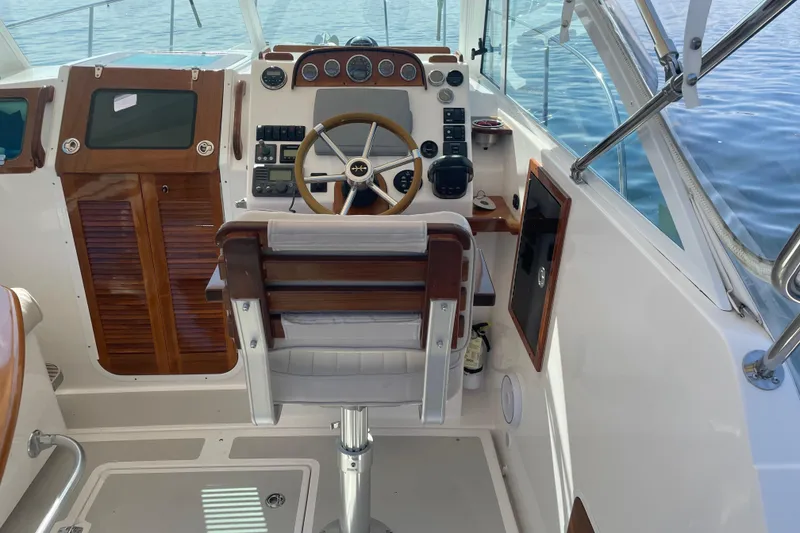 Slide: The Image of 2012 Hunt Surfhunter boat cockpit with wooden steering wheel and control panel. - 20