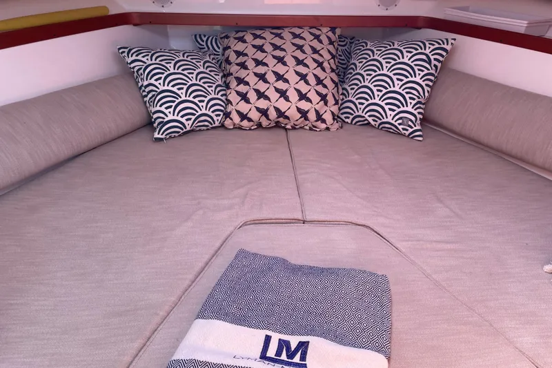 Slide: The Image of Cozy cabin interior of 2012 Hunt Surfhunter with patterned pillows and blanket. - 3