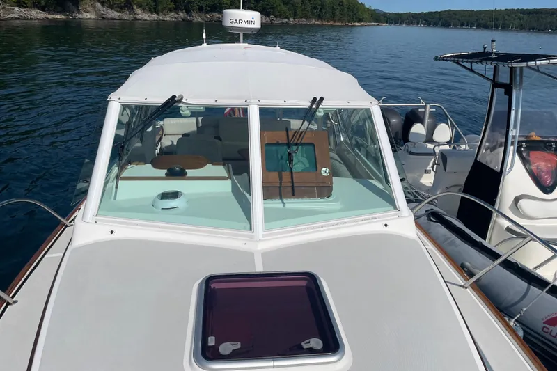 Slide: The Image of 2012 Hunt Surfhunter boat on calm lake with Garmin equipment. - 6