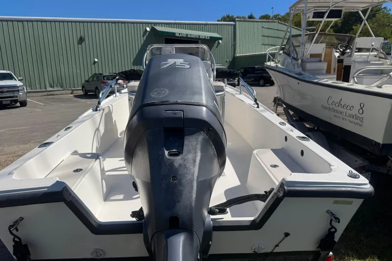 Slide: The Image of 2006 Mako 171 Center Console boat with 75 HP engine in a marina setting. - 10