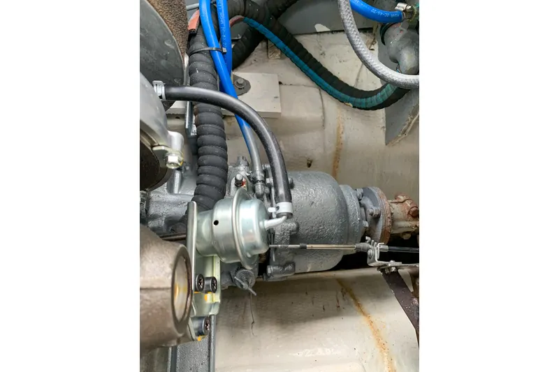 Slide: The Image of Engine components of a 1980 SISU 26, featuring hoses and mechanical parts. - 17