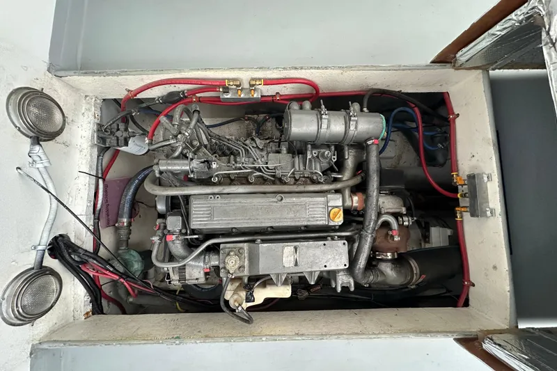 Slide: The Image of 1980 SISU 26 engine compartment with visible wiring and components. - 18