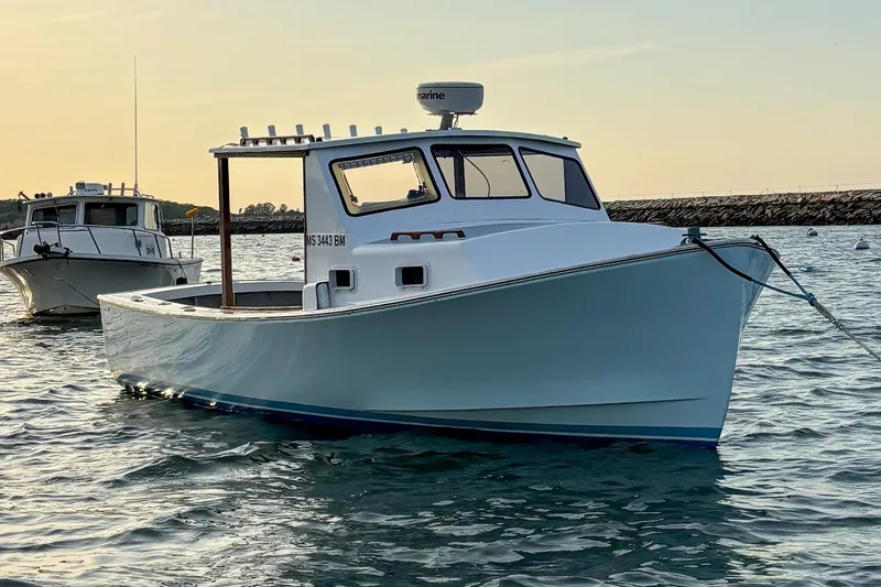 Slide: The Image of 1980 SISU 26 boat anchored in calm waters at sunset. - 2