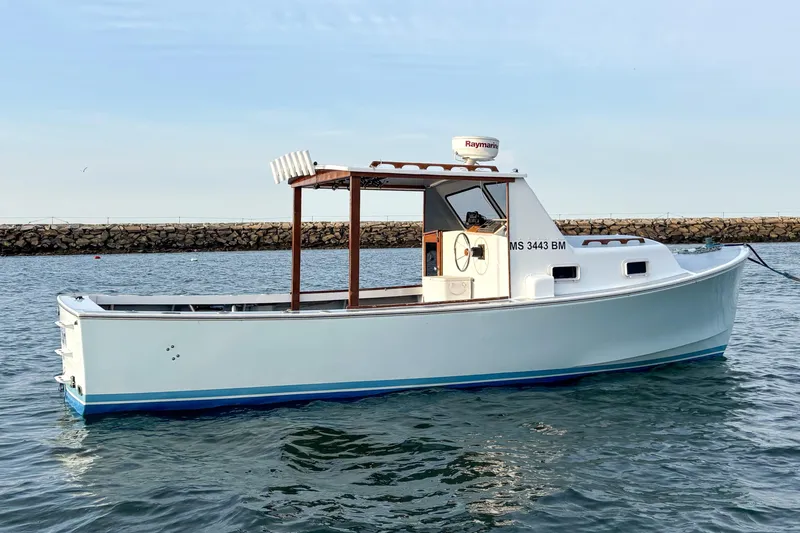 Slide: The Image of 1980 SISU 26 boat on water, white hull, open cabin, Raymarine radar, calm sea. - 3