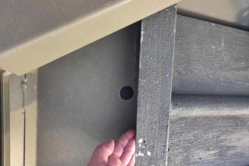 Slide: The Image of Hand inspecting a 2018 Tracker Grizzly 1648 boat's interior structure. - 14