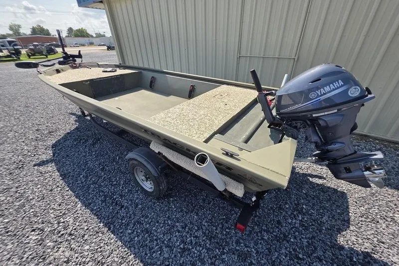 Slide: The Image of 2018 Tracker Grizzly 1648 boat with outboard motor on gravel lot. - 4