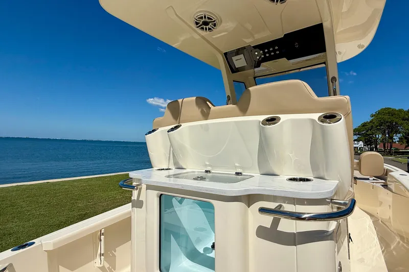 Slide: The Image of 2025 Scout 261 XSS boat interior with seating and ocean view. - 15